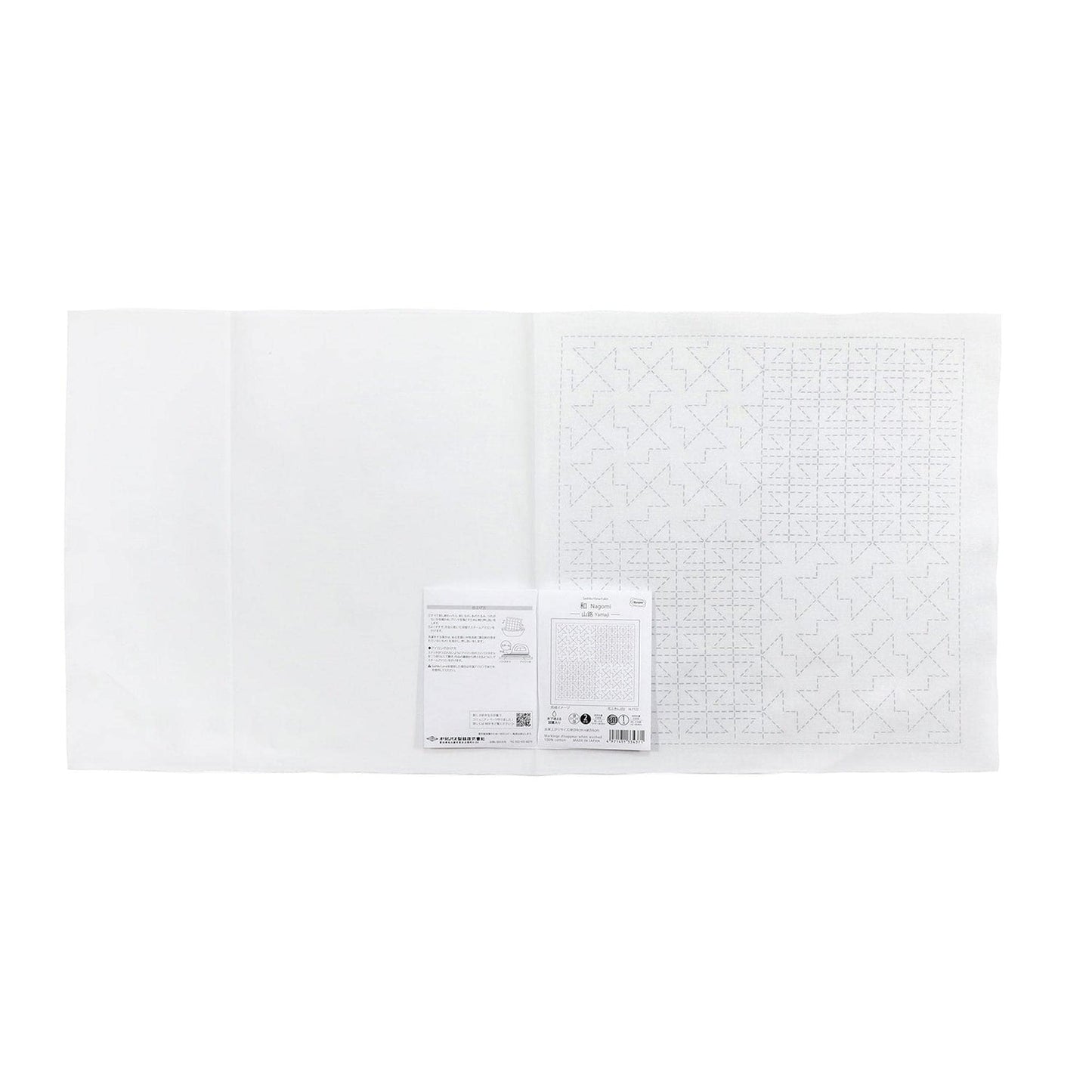 The image is a white sheet of paper with a grid pattern on it, and there is a small piece of paper with text next to it.