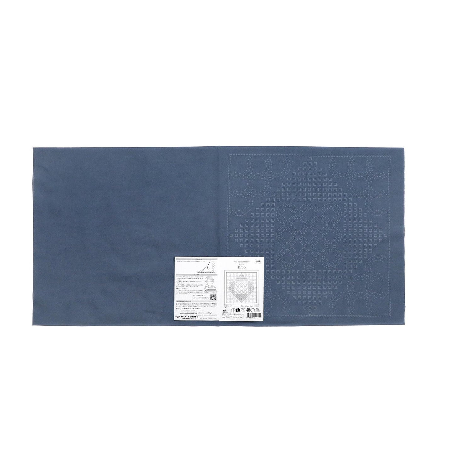 The image is a blue fabric with a white label attached to it.