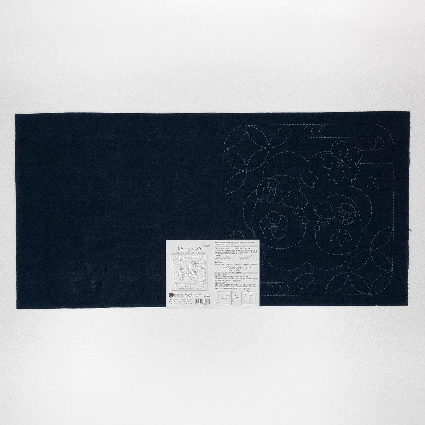 a dark blue fabric with a white label attached to it, which appears to be a sewing or crafting material.