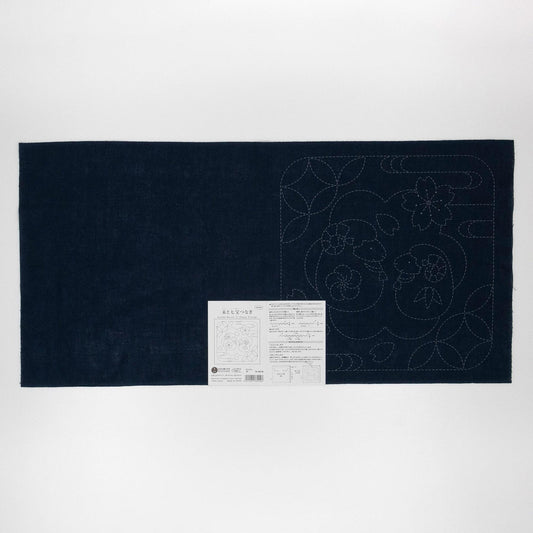 a dark blue fabric with a white label attached to it, which appears to be a sewing or crafting material.