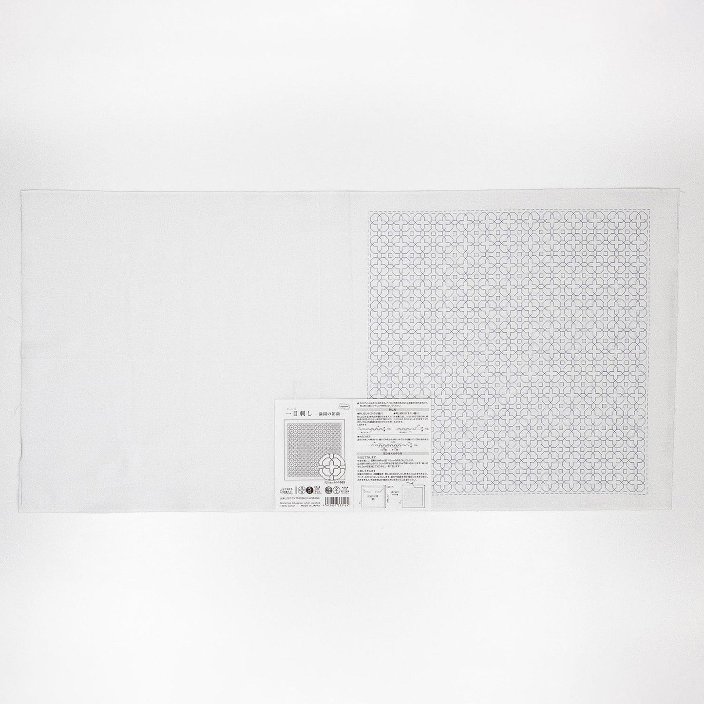 The image is a white sheet of paper with a black and white geometric pattern on it.
