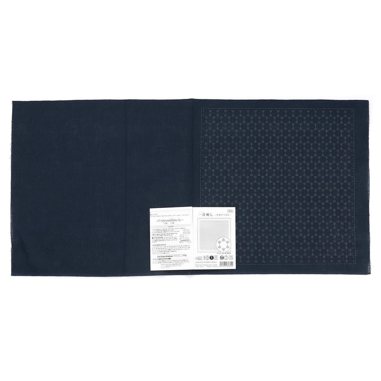 The image is a black fabric with a white label attached to it, which appears to be a product label or instructions.