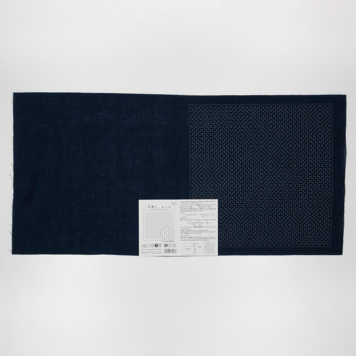 The image is a black fabric with a white label placed on it.