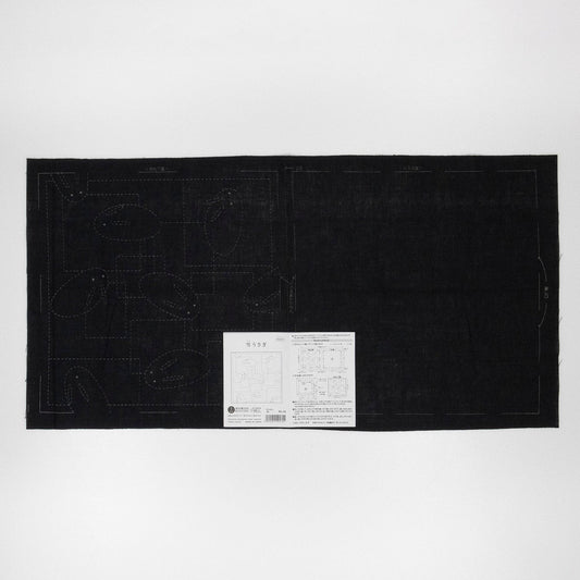 The image is a black square with a white label in the center, which appears to be a piece of paper or a printed document.