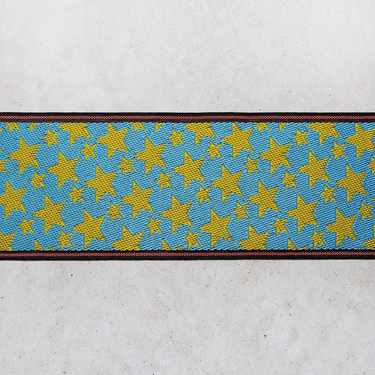 a repeating pattern of blue and yellow stars on a white background.