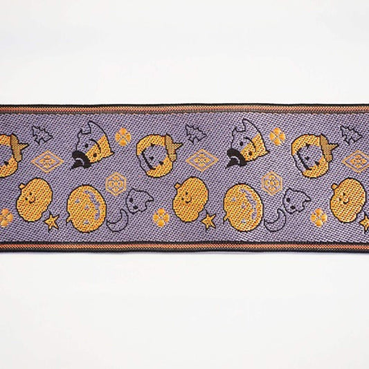 a repeating pattern of Halloween-themed pumpkins and bats on a purple background.