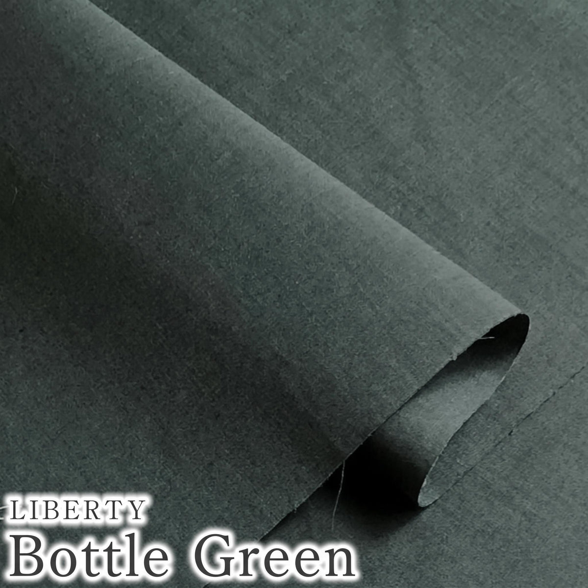 A close-up view of a dark green fabric, possibly a bottle green, with the text "LIBERTY Bottle Green" overlaid on the image.