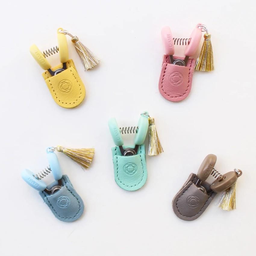 a group of small clips with tassels on them