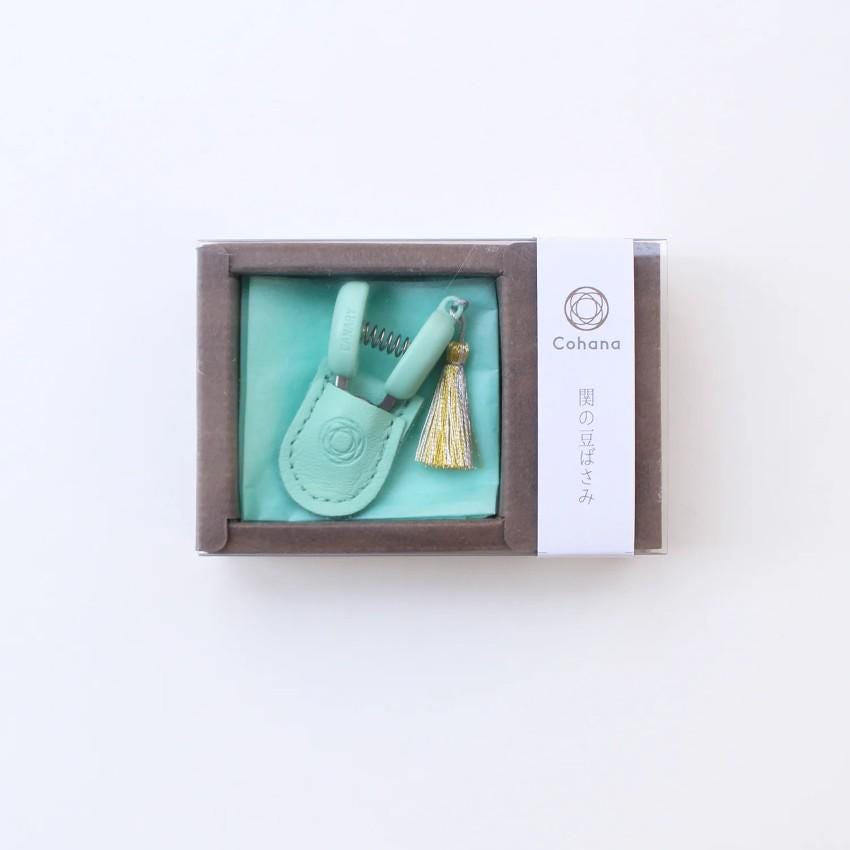 a green case with a tassel inside of it