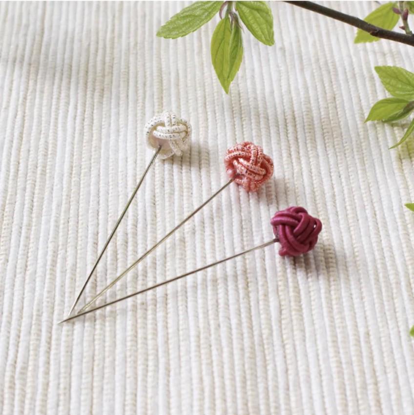 a couple of pins sitting on top of a table