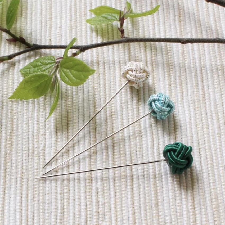a couple of pins sitting on top of a table