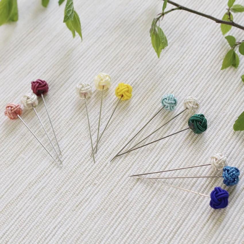 a bunch of pins sitting on top of a table