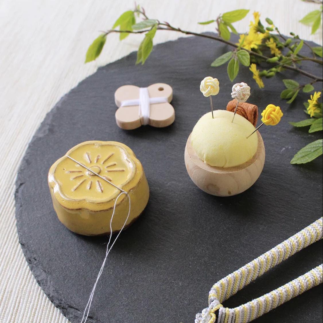 a black slate with a yellow and white decoration on it