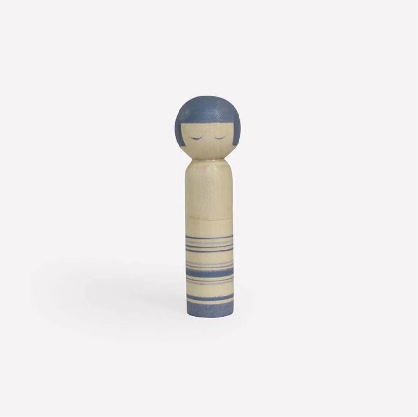 a small wooden doll with a blue nose