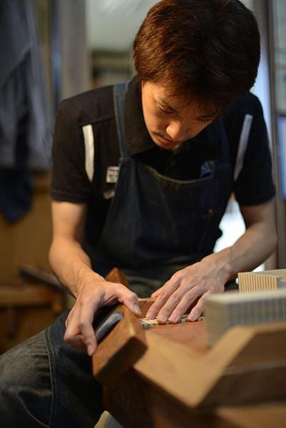 a man working on a piece of wood
