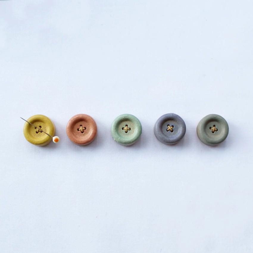 a row of buttons sitting on top of a white surface