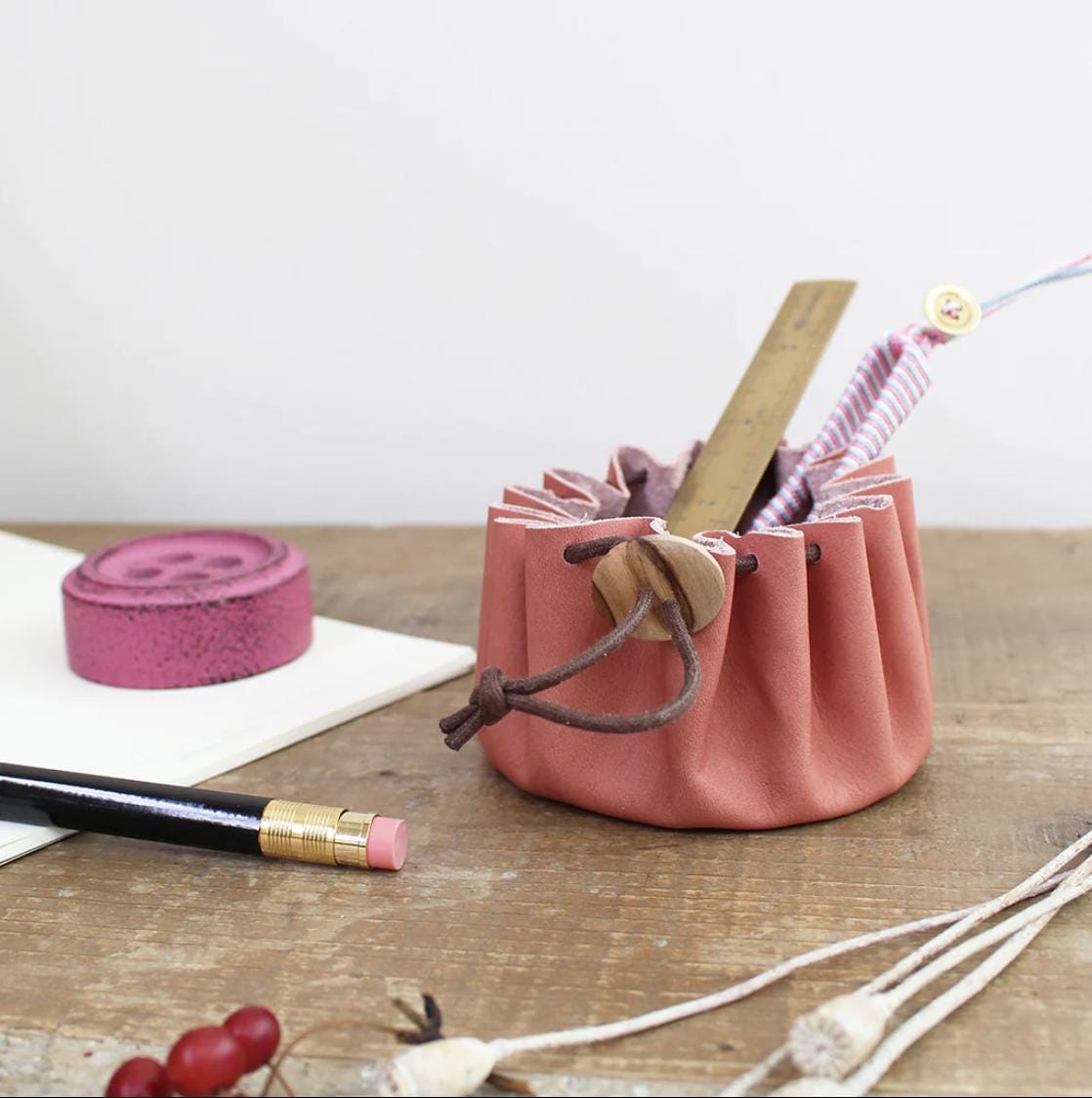 a pencil holder with a pen and a pencil