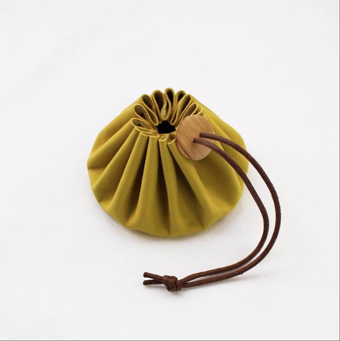 a small yellow bag with a wooden handle