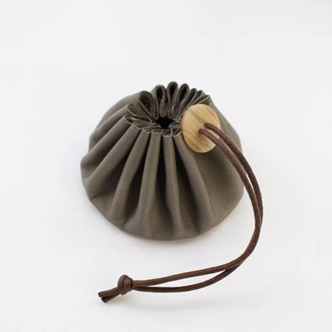 a round object with a wooden handle on a white surface