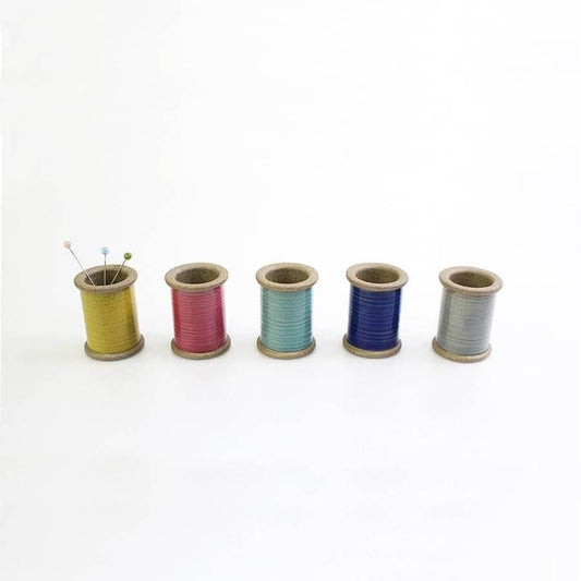 four spools of thread sitting next to each other