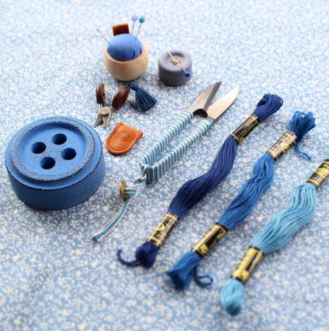 a table topped with different types of sewing supplies