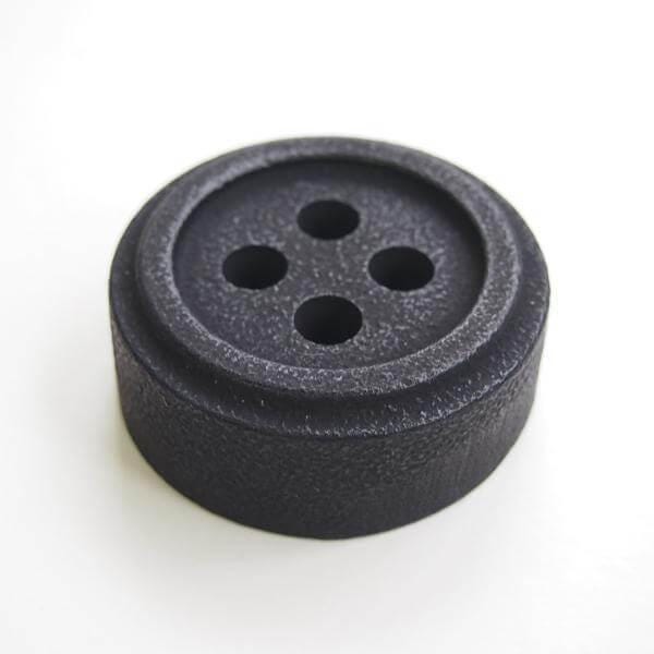 a close up of a button on a white surface