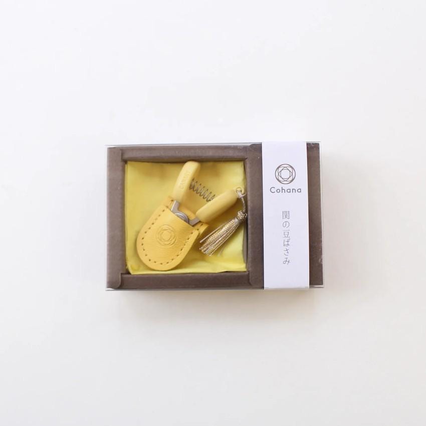 a yellow toothbrush in a box on a white surface