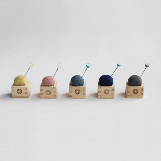 a row of different colored balls of yarn
