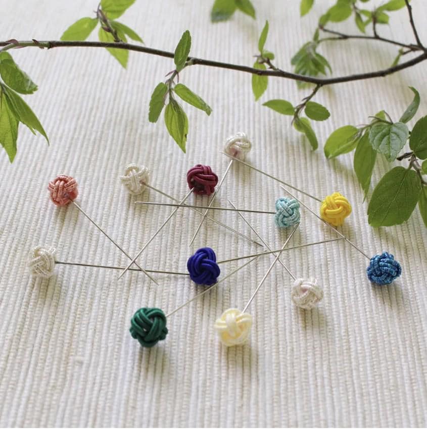a bunch of pins sitting on top of a table