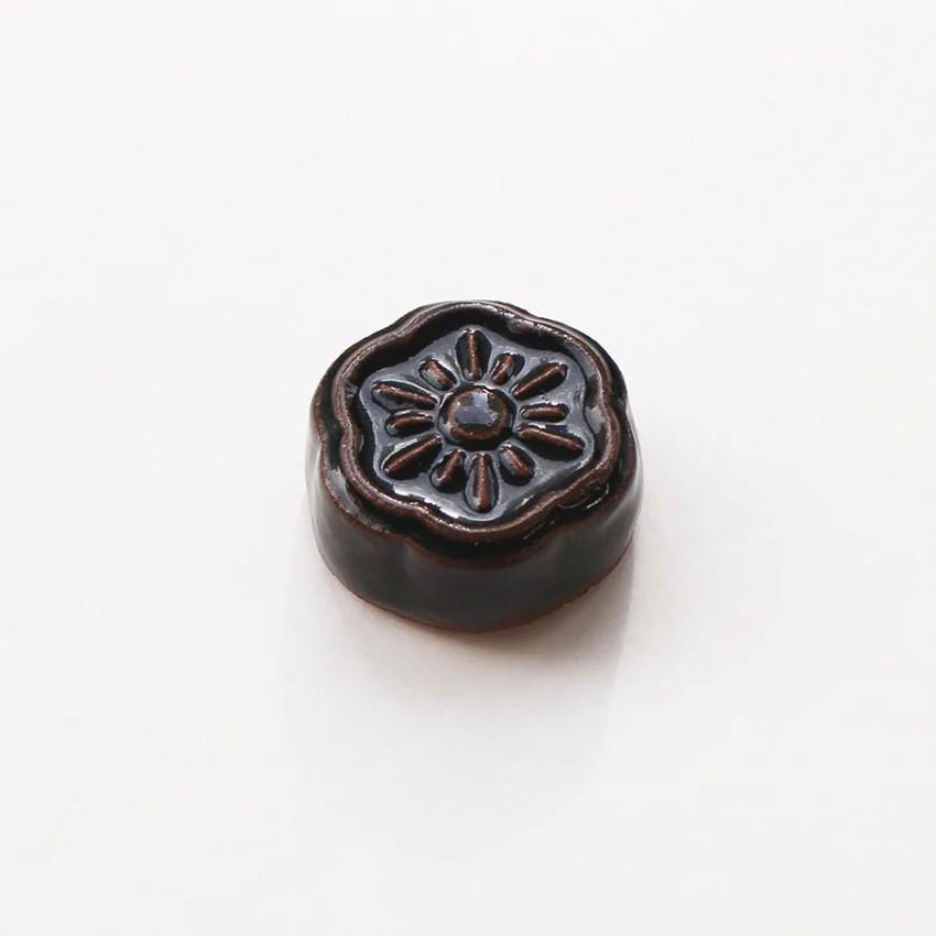 a close up of a button on a white surface