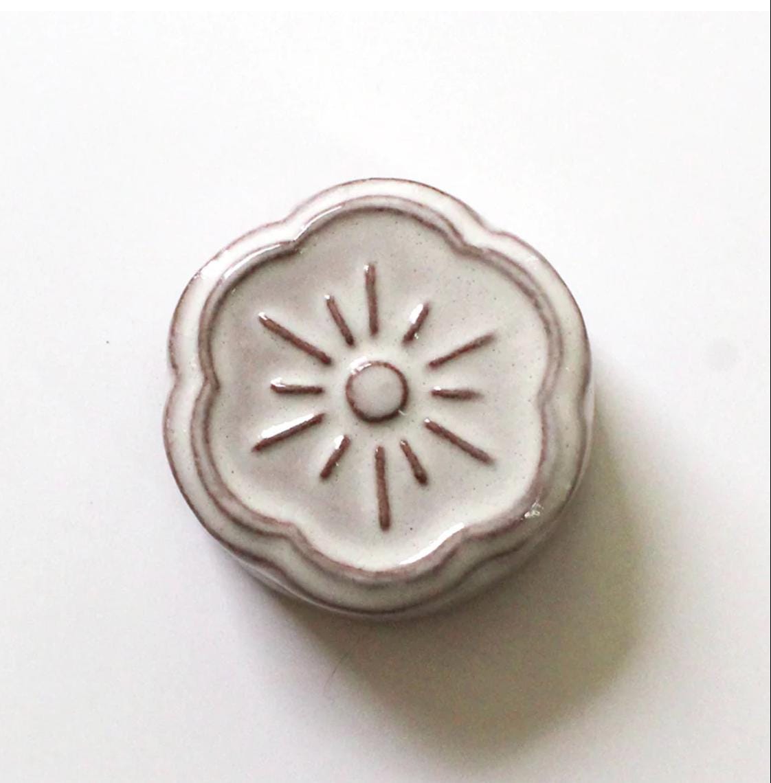 a close up of a metal object on a white surface