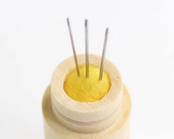 a white container with a yellow substance inside of it