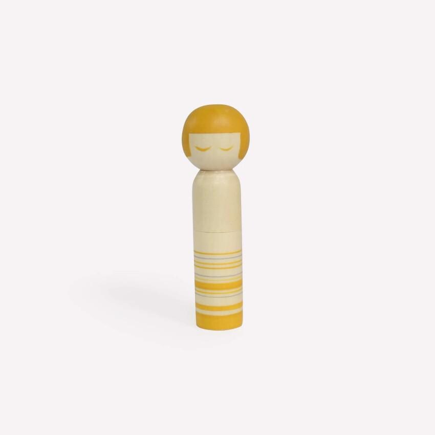 a yellow and white wooden doll on a white background
