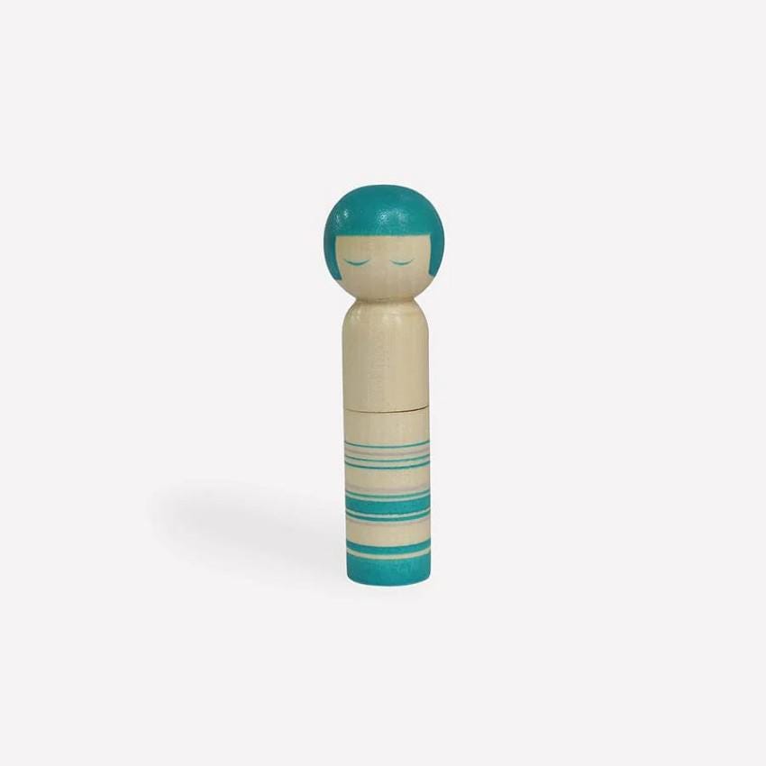 a small wooden doll with a blue top