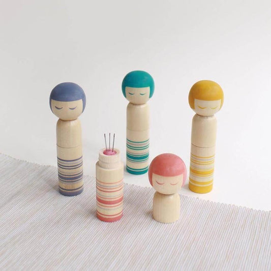 a group of wooden dolls sitting next to each other