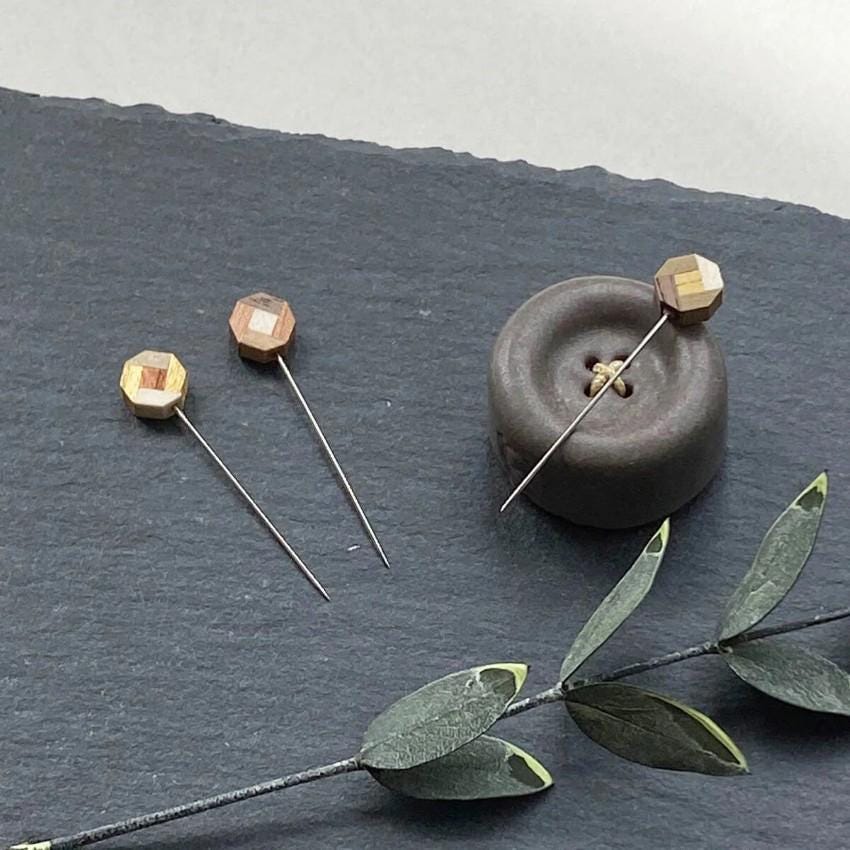 a couple of pins sitting on top of a table