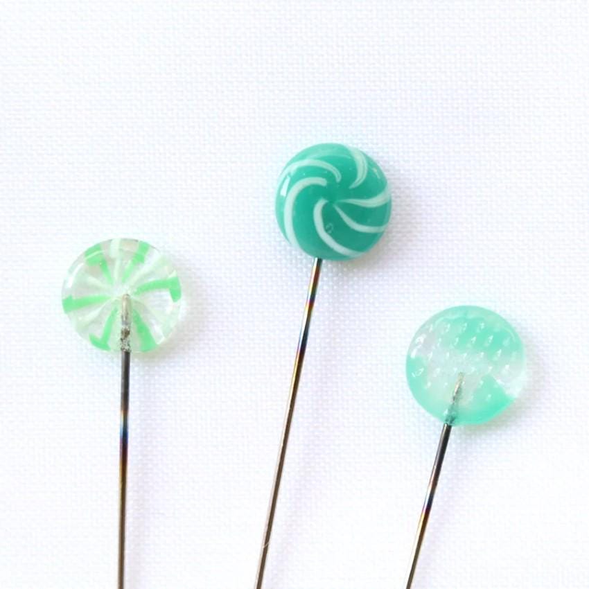 three green lollipops sitting on top of each other