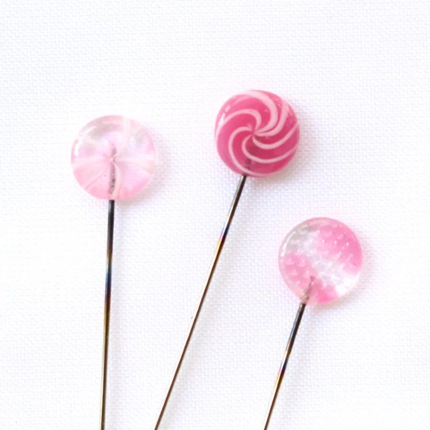 three candy lollipops sitting on top of each other