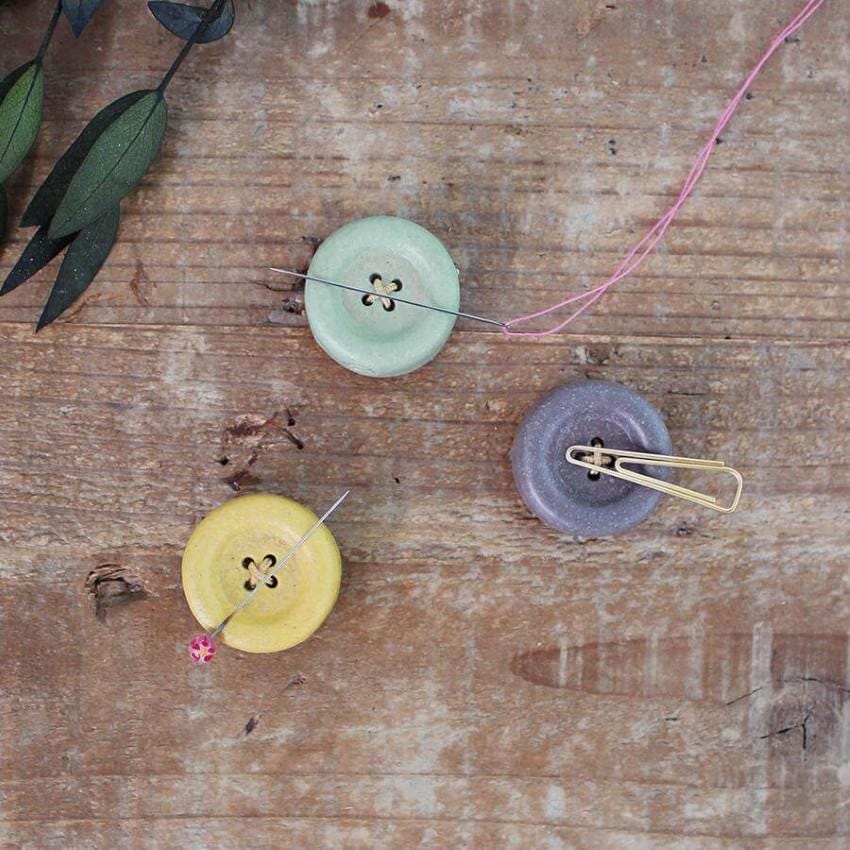 a couple of buttons sitting on top of a wooden table
