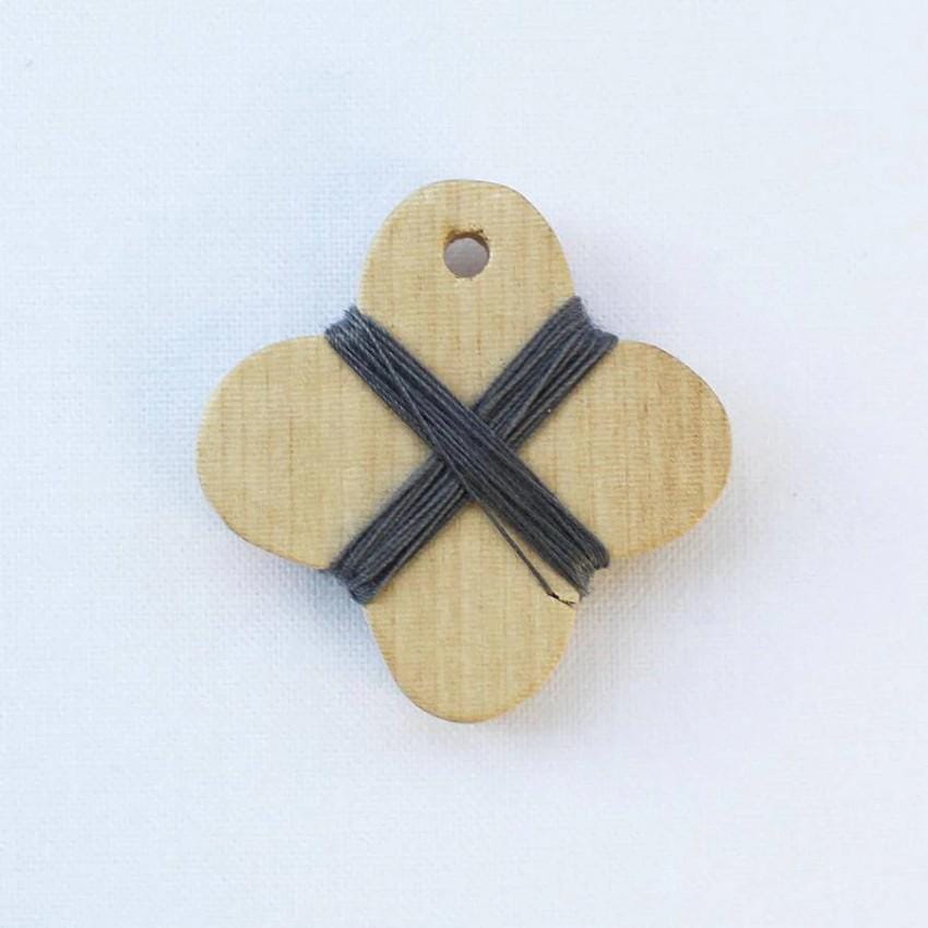 a wooden tag with a cross on it
