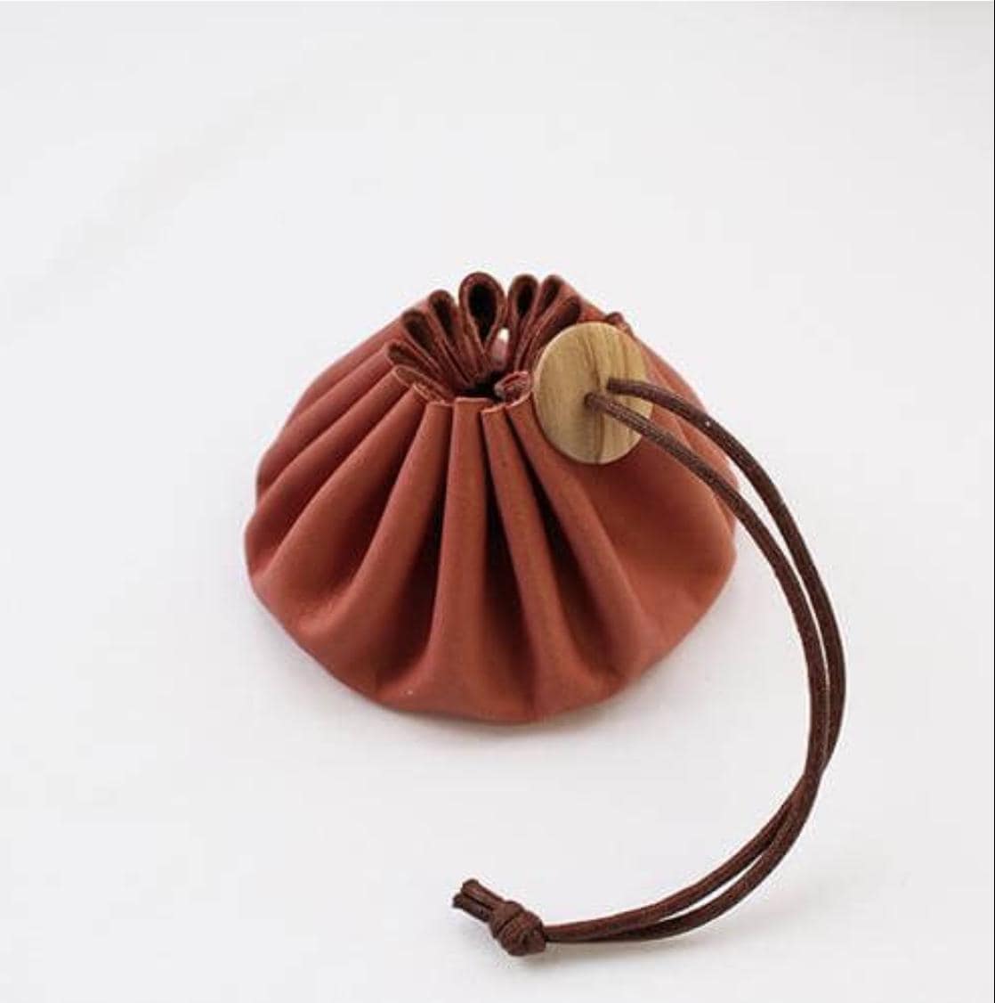a brown bag with a wooden button on it