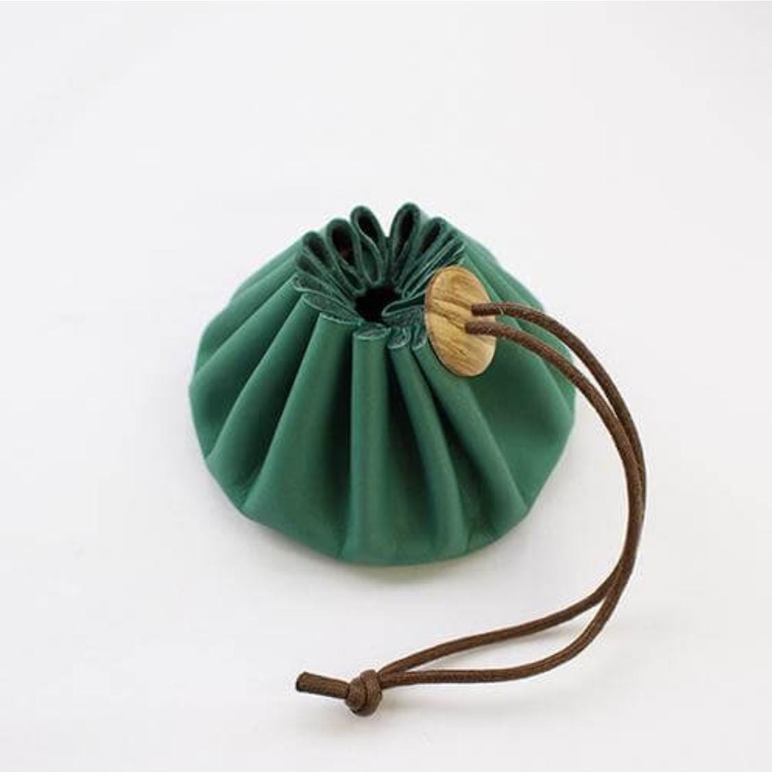 a small green bag with a wooden handle