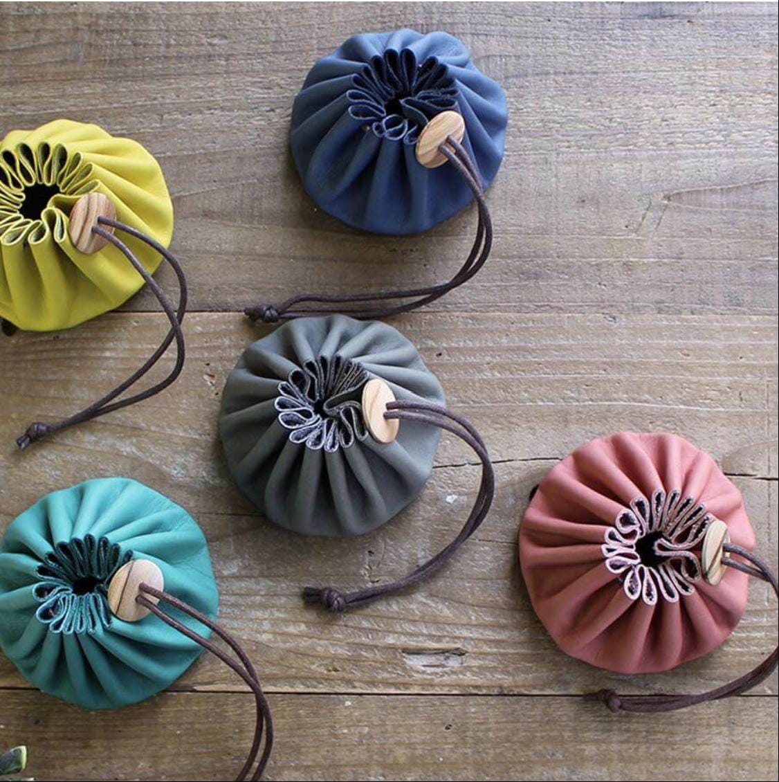 a group of purses sitting on top of a wooden floor