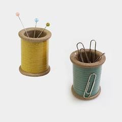a couple of spools of thread sitting next to each other
