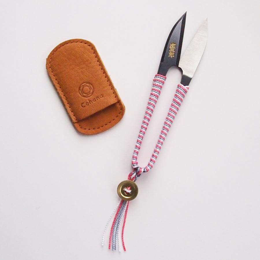 a pair of scissors sitting next to a wallet