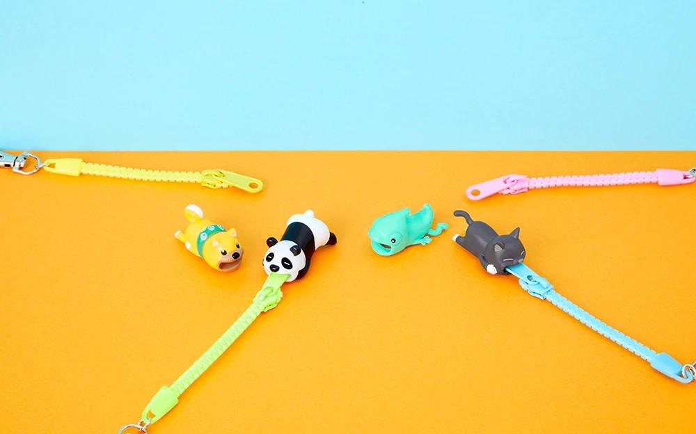 a group of small toy animals on a yellow surface