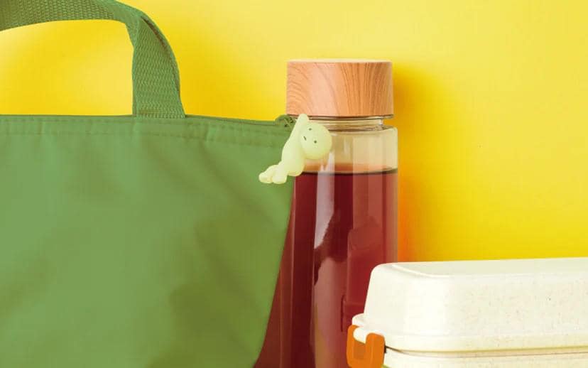 a bottle of juice next to a plastic container