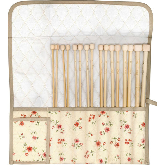 a crib with a flowered blanket and wooden crib rails
