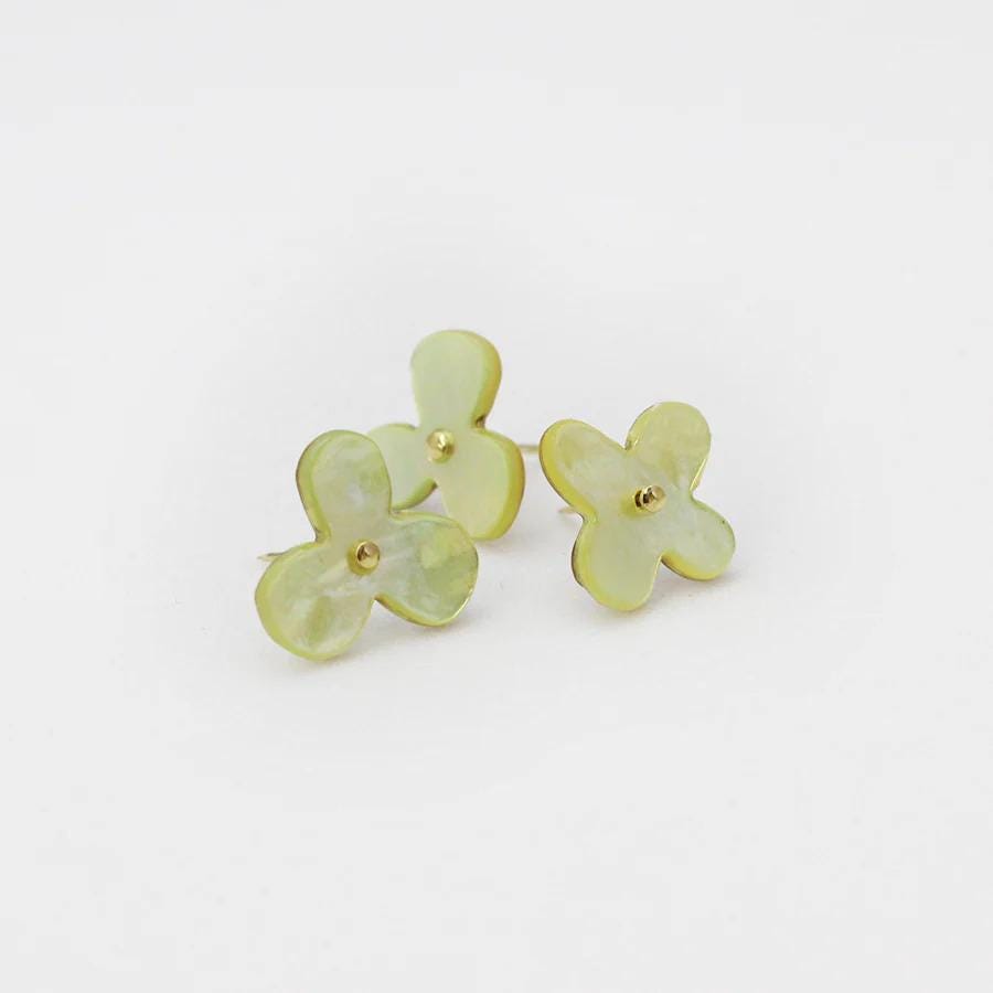 Three green flower-shaped earrings are displayed against a white background.