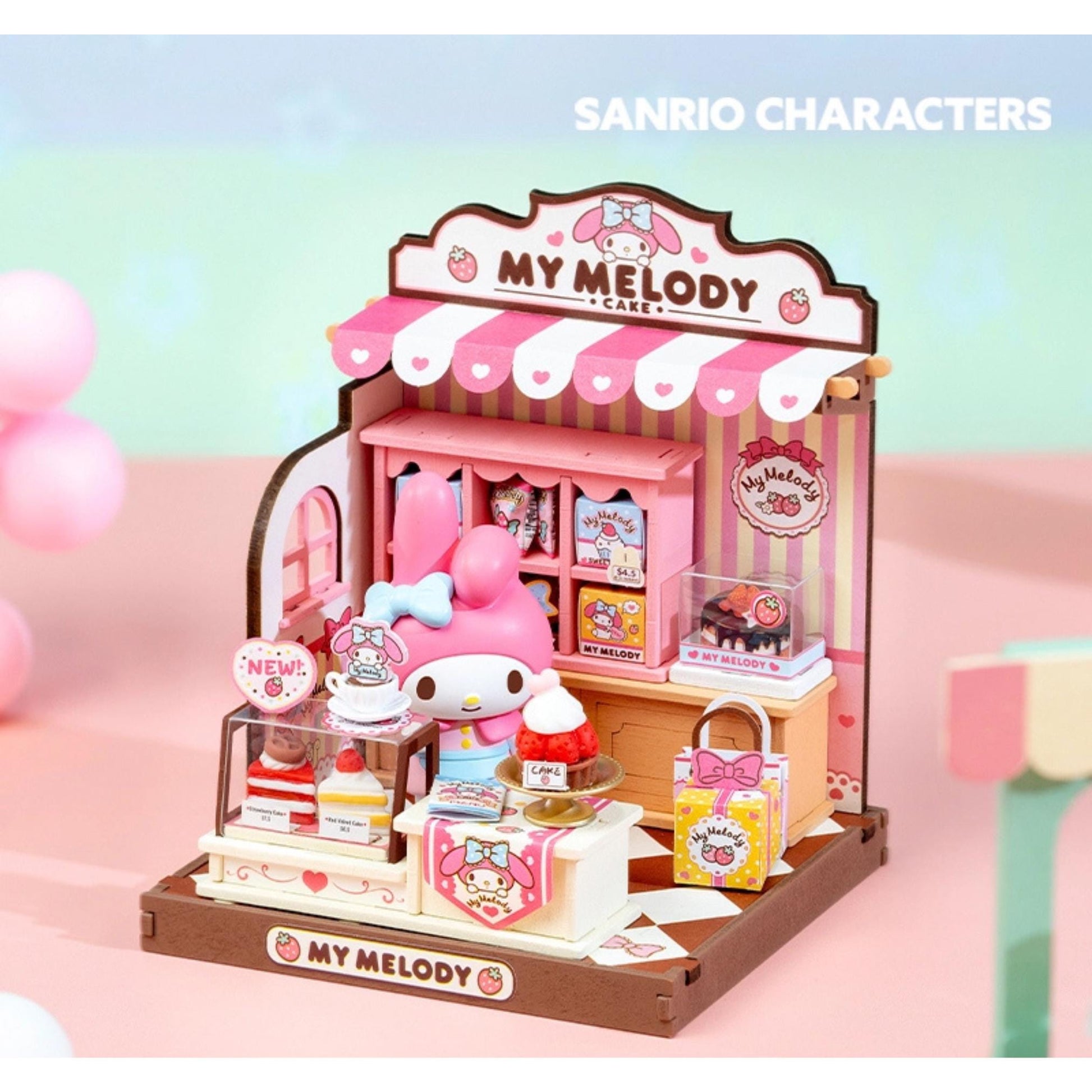 A miniature toy shop display featuring a Hello Kitty figurine and various Hello Kitty-themed items, including a pink and white striped awning, a pink and white striped sign, and a pink and white striped display case.